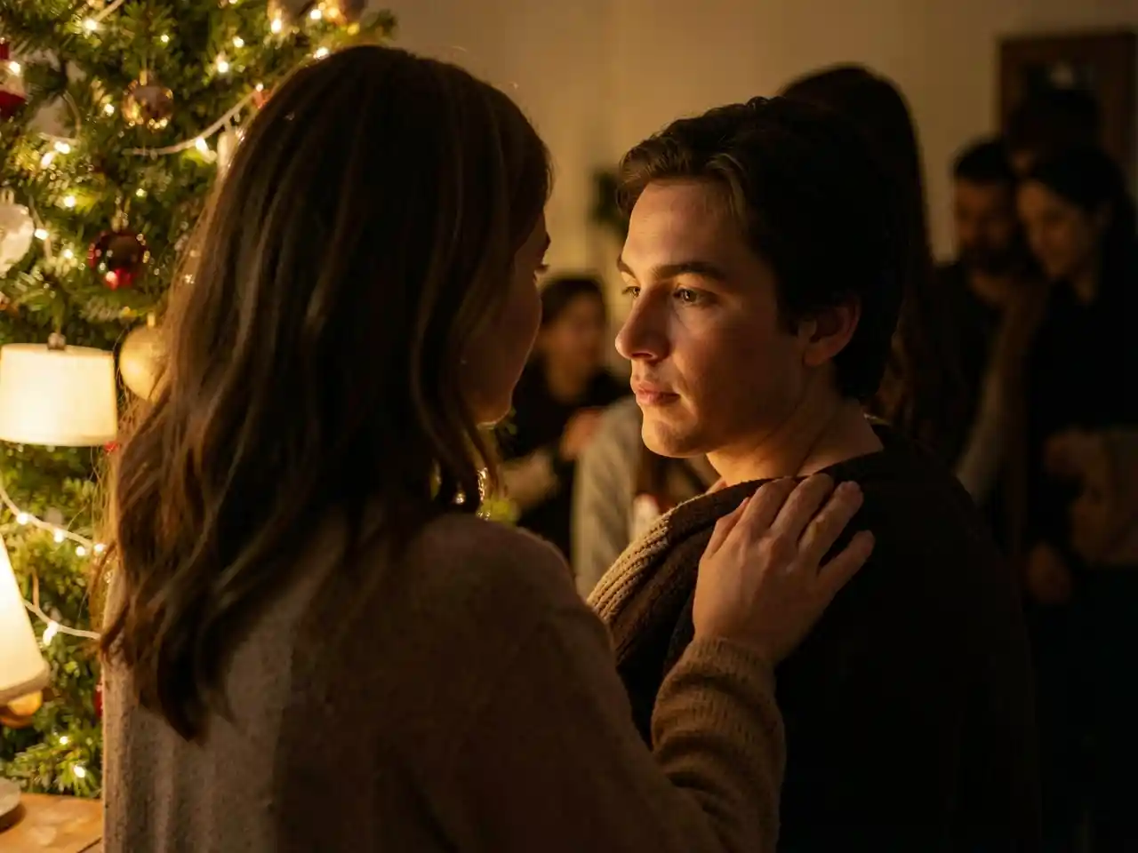 A mother gently touching her adult child's shoulder by a warm Christmas tree, symbolizing the shelter of home and the enduring strength of love.