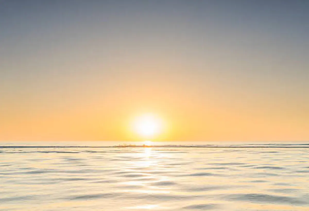 Sunrise over calm ocean symbolizing emotional renewal and harmony within the self