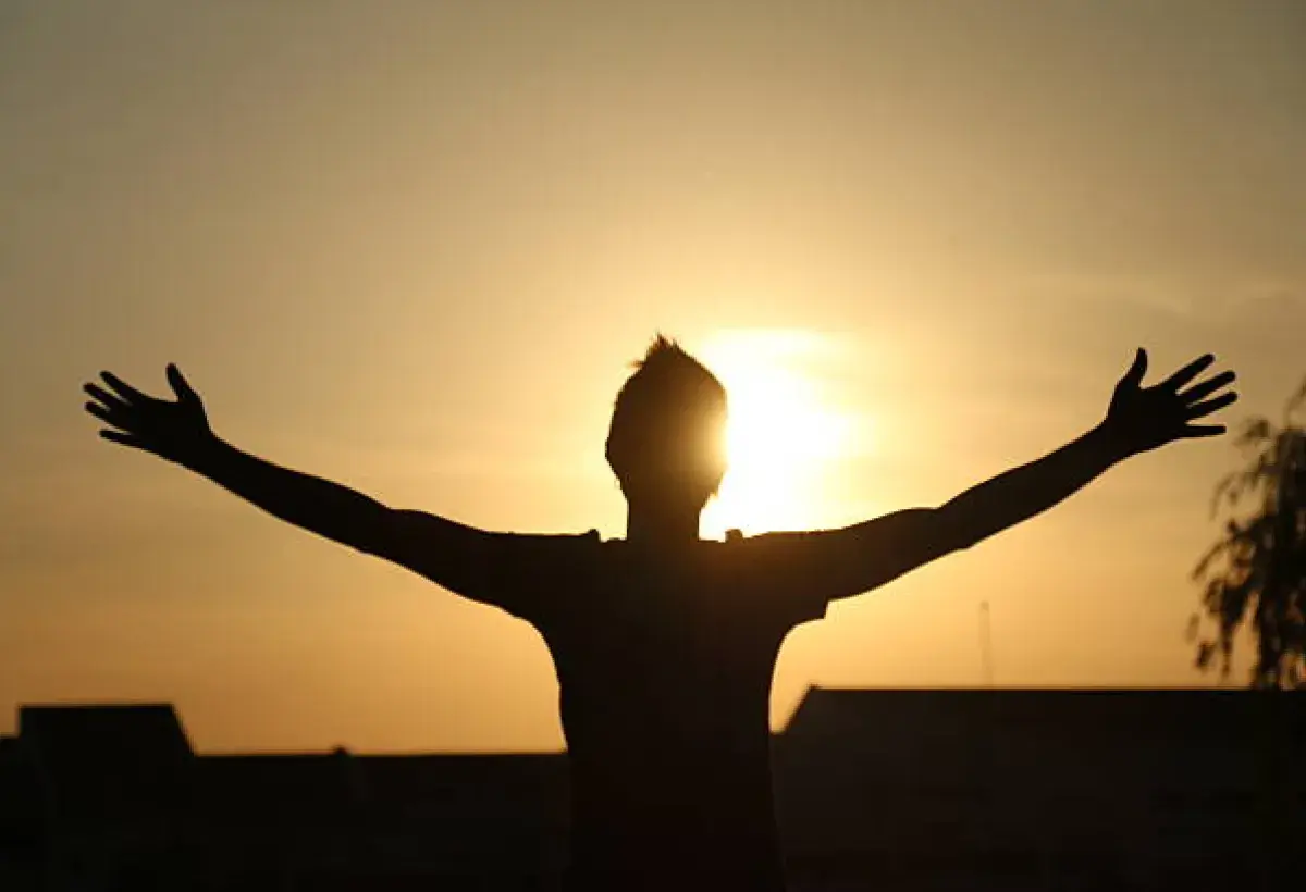 Hands lifted toward the sky representing openness to God’s presence