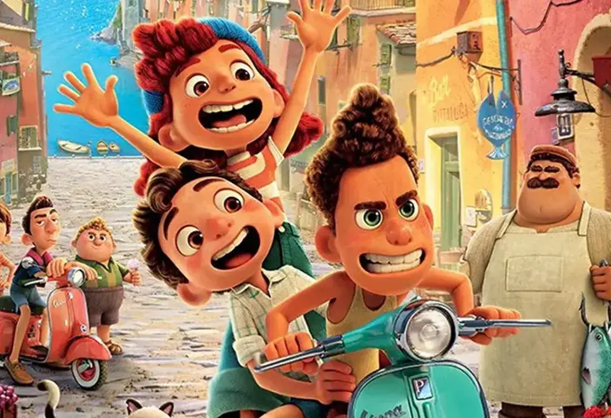 Luca riding the Vespa celebrated by the village