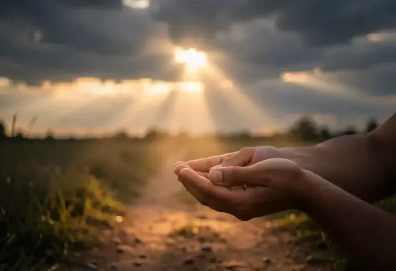 A single ray of sunlight breaking through dark clouds onto an open path, symbolizing hope, divine restoration, and life returning to what seemed lost