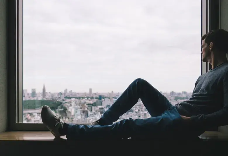 contemplating man by the window