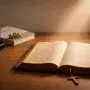 An ancient Bible illuminated beside modern wellness items, symbolizing the timeless, freely available wisdom versus the purchased peace of today.
